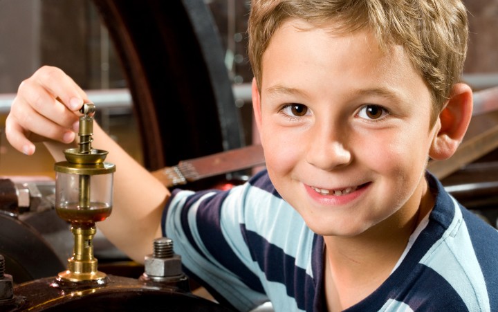 Boy on a steam engine model