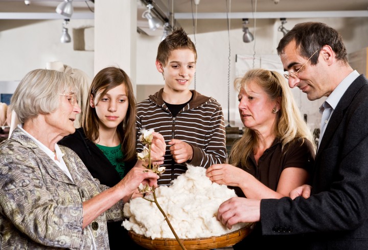 Family examines raw cotton together