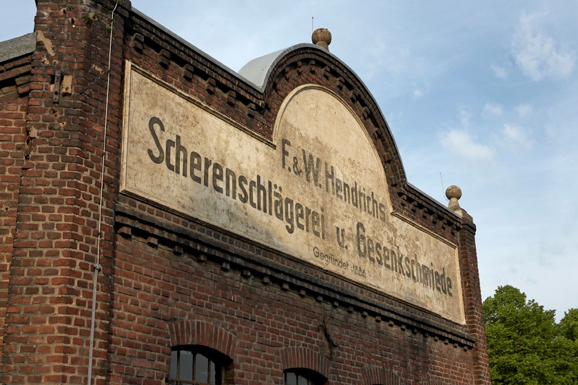 Corner facade of the Gesenkschmiede Hendrichs (Drop Forge). This was the only part of the exterior, which can claim to have an aesthetic appearance. The drop forges – also referred to as hammering shops – being green-ware producers – were so to say the backroom of industry in Solingen.